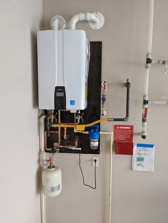 Professional plumber installing copper piping in a Austintown home